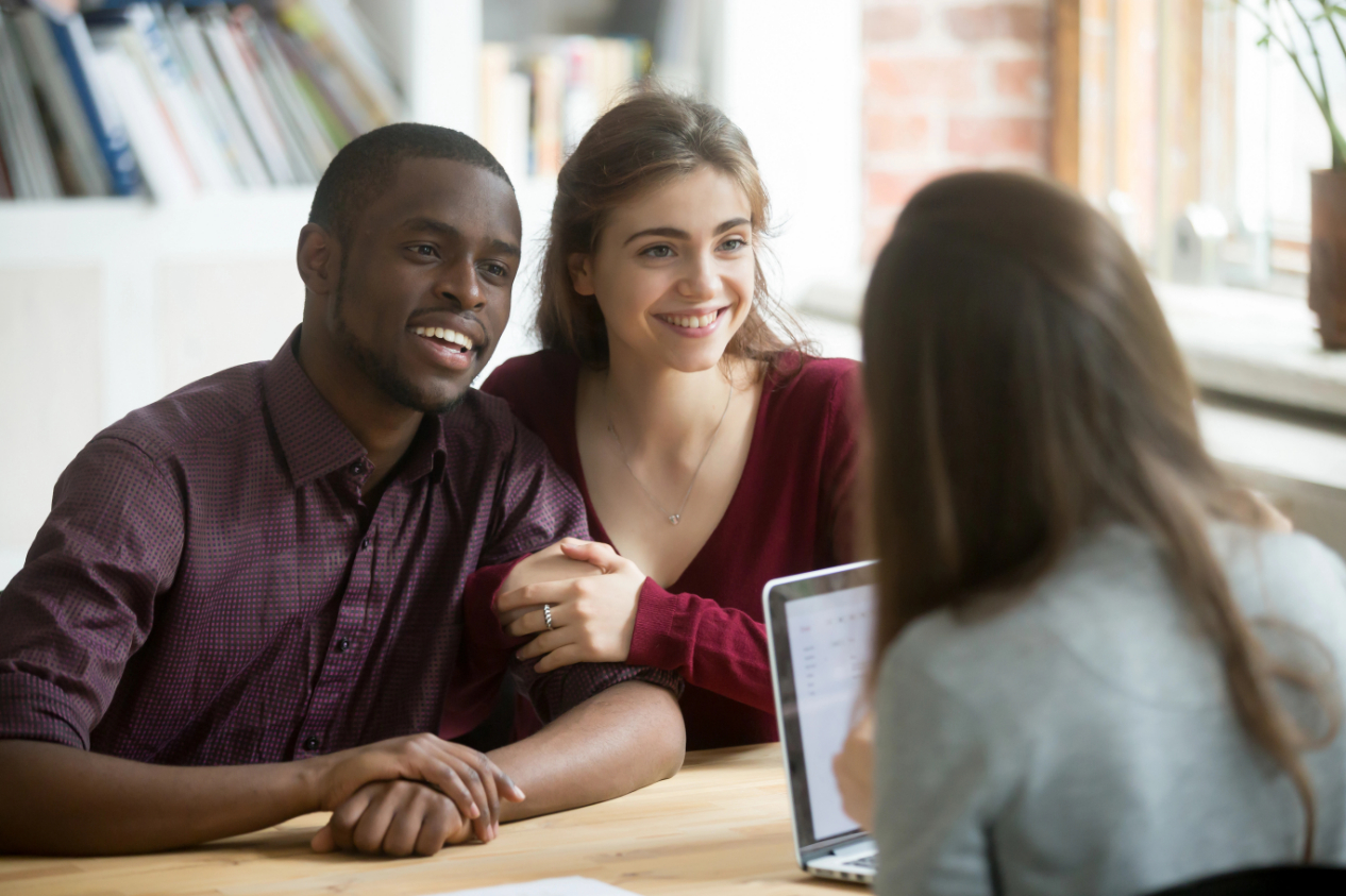 Happy multiracial couple excited about contract signing